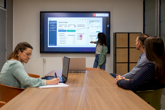 Développeur et chef de projet en réunion client pour validation analyse e-commerce sur écran interactif